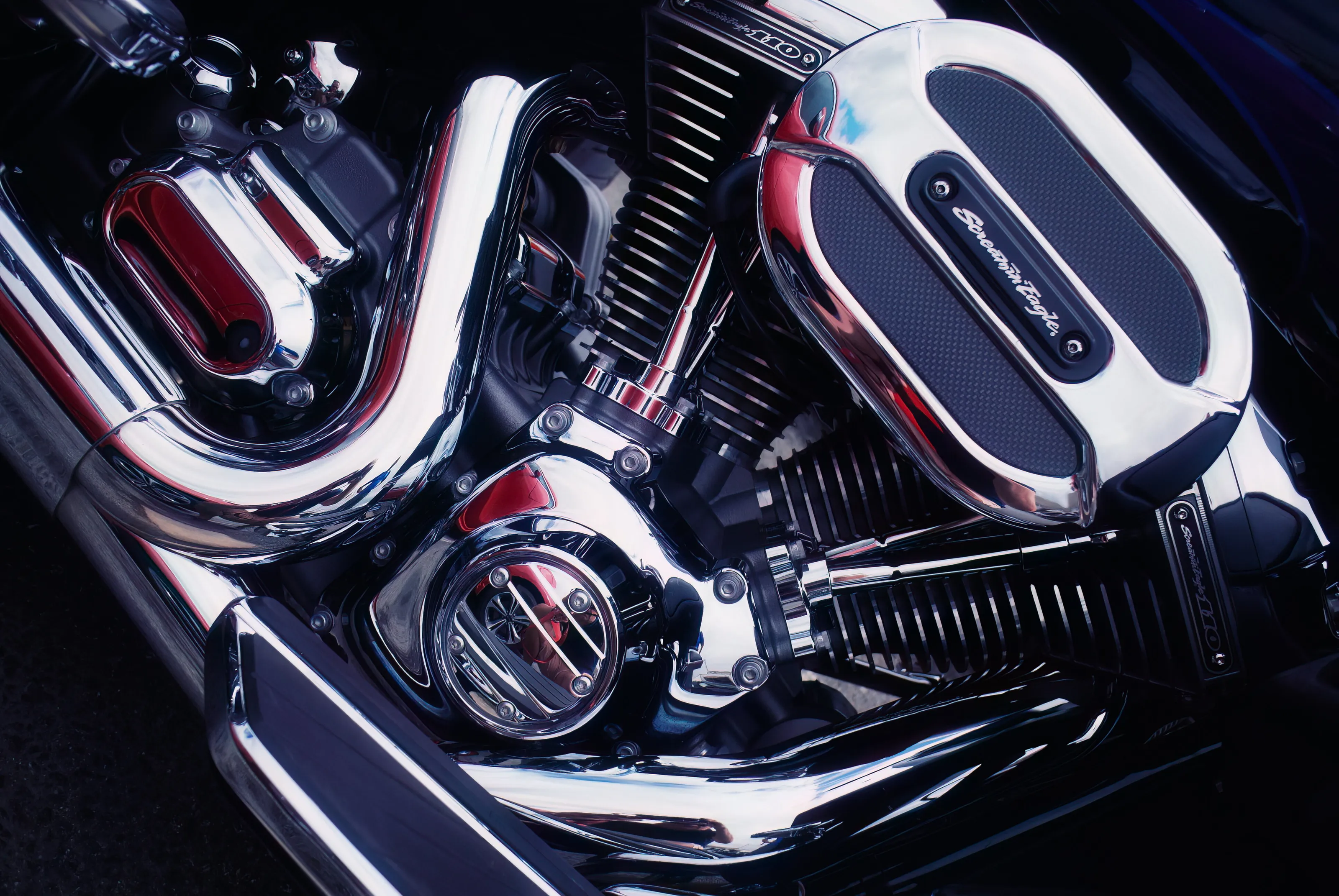 Motorbike engine chrome black, blue and red close up