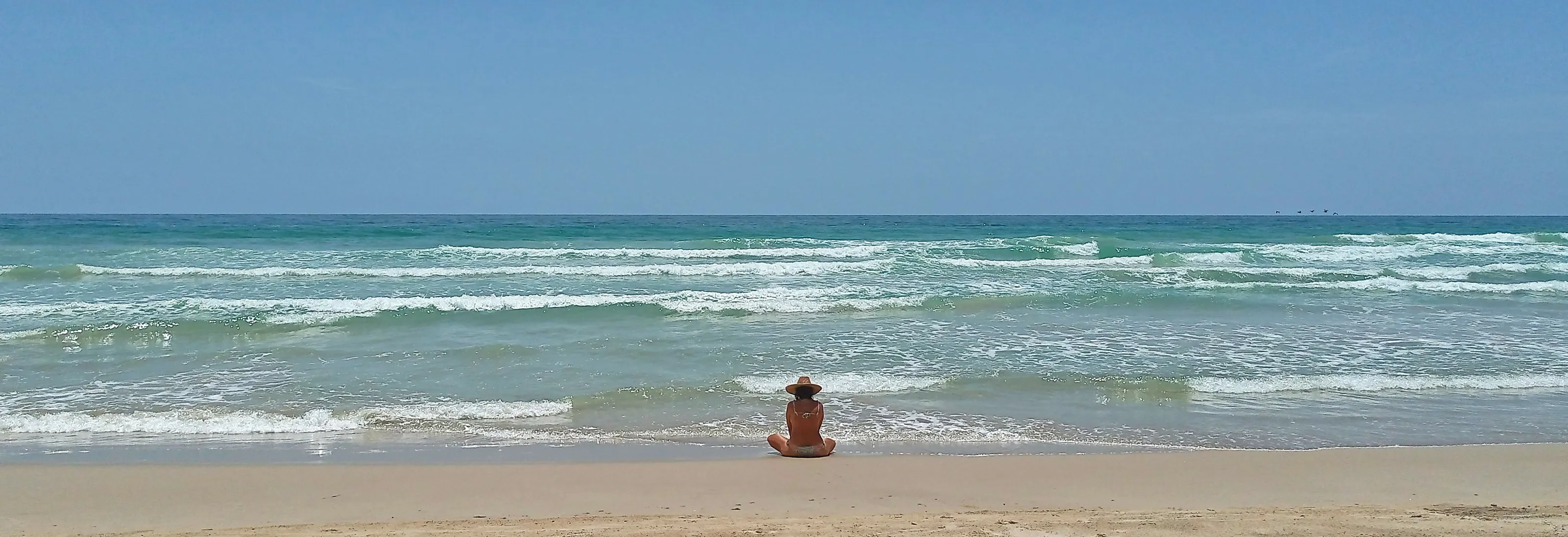 A woman with a hat in the Caribbean