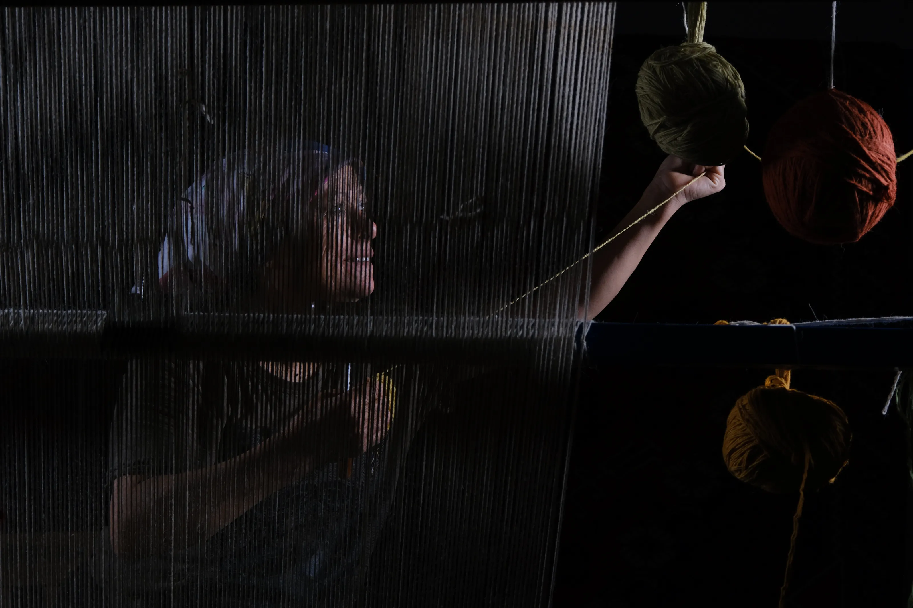 Threads of Tradition: A Woman Weaving a Carpet