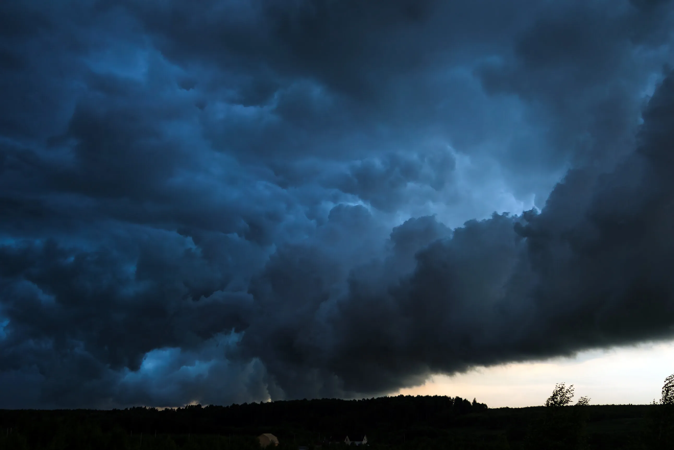 Summer landscape with black storm clouds