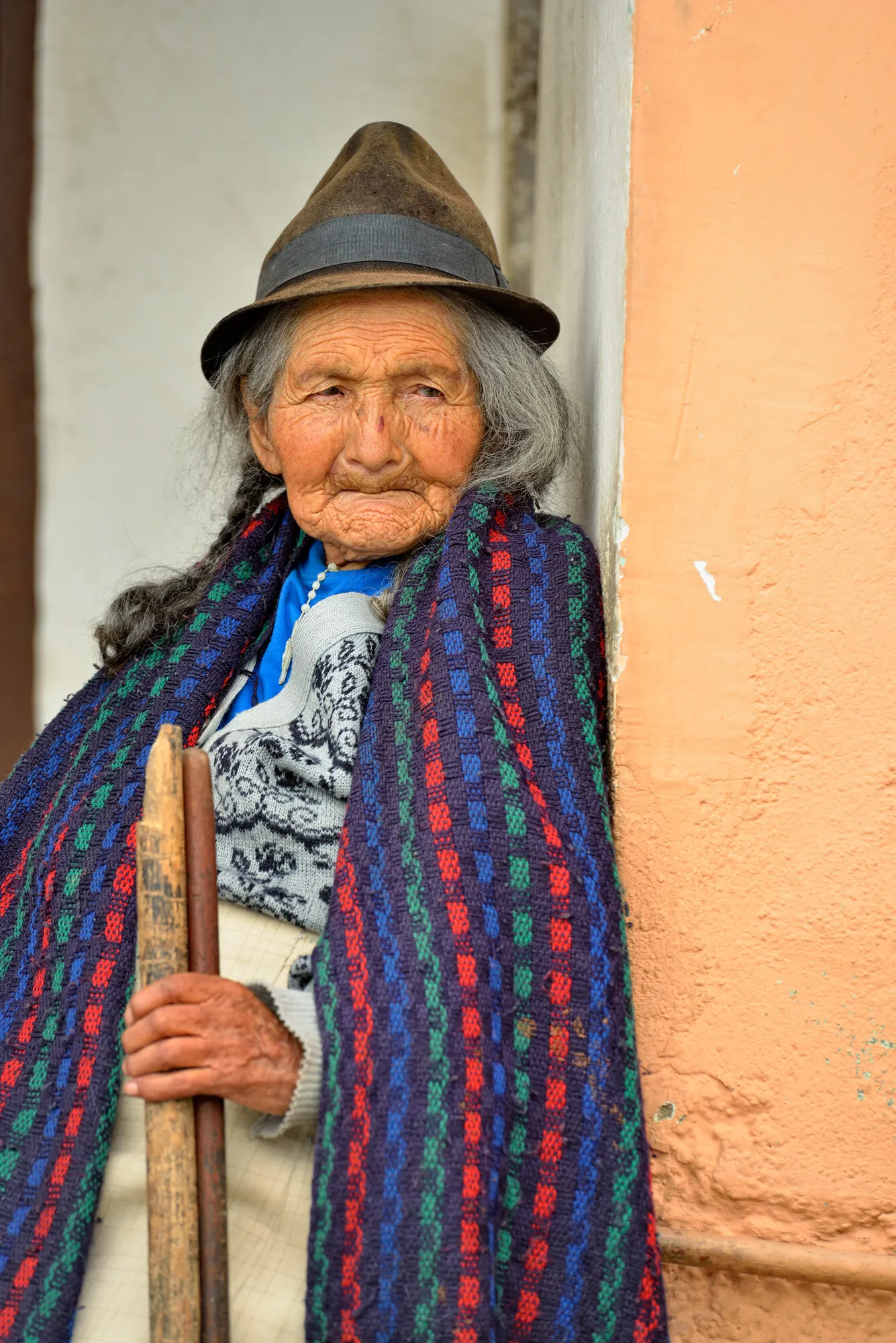 A senior citizen in Nono, relaxing on a street porch, Nono, Pichincha, Ecuador