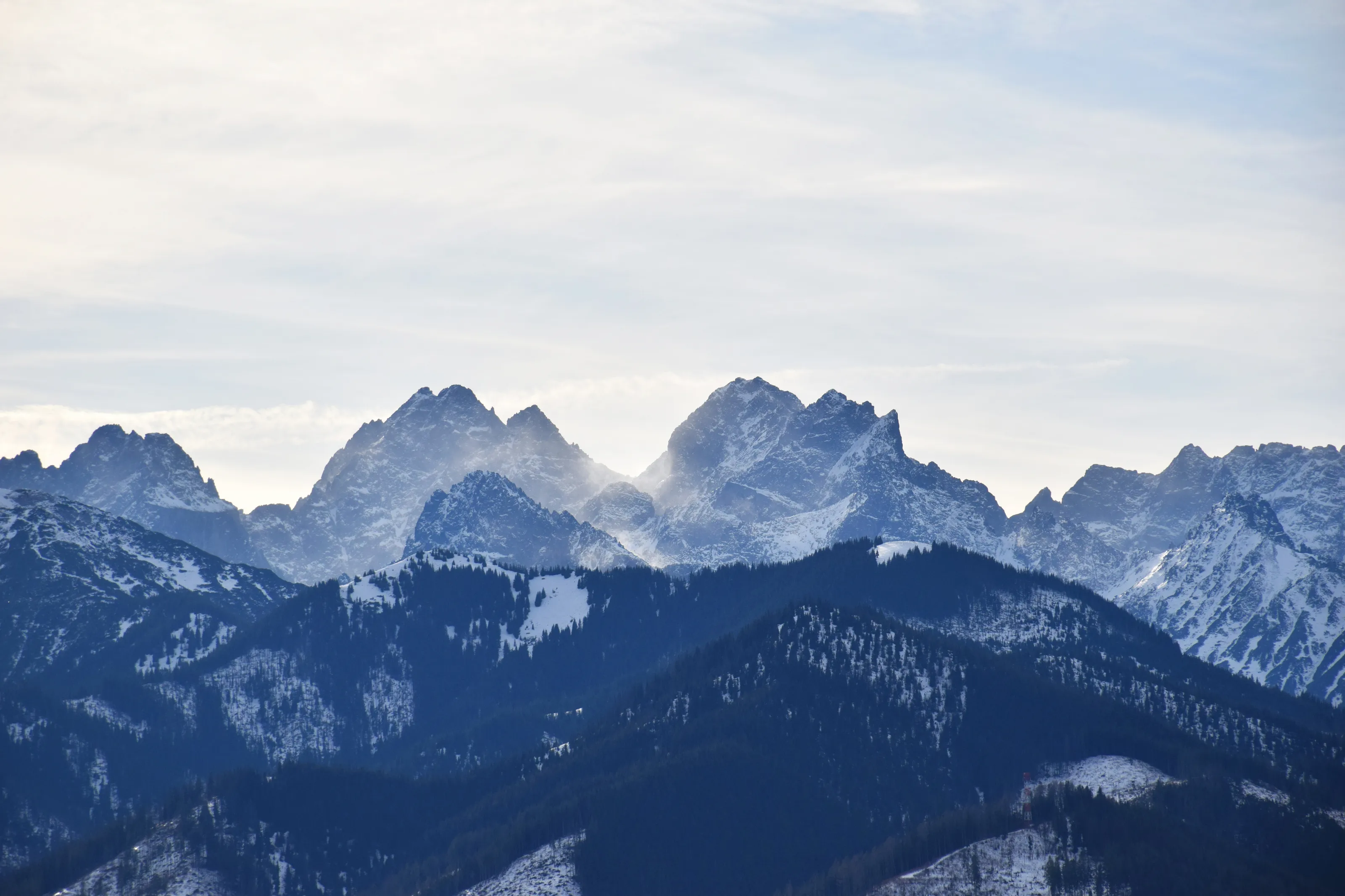 Snow-Covered High Tatras Mountain Peaks with Misty Alpine Air