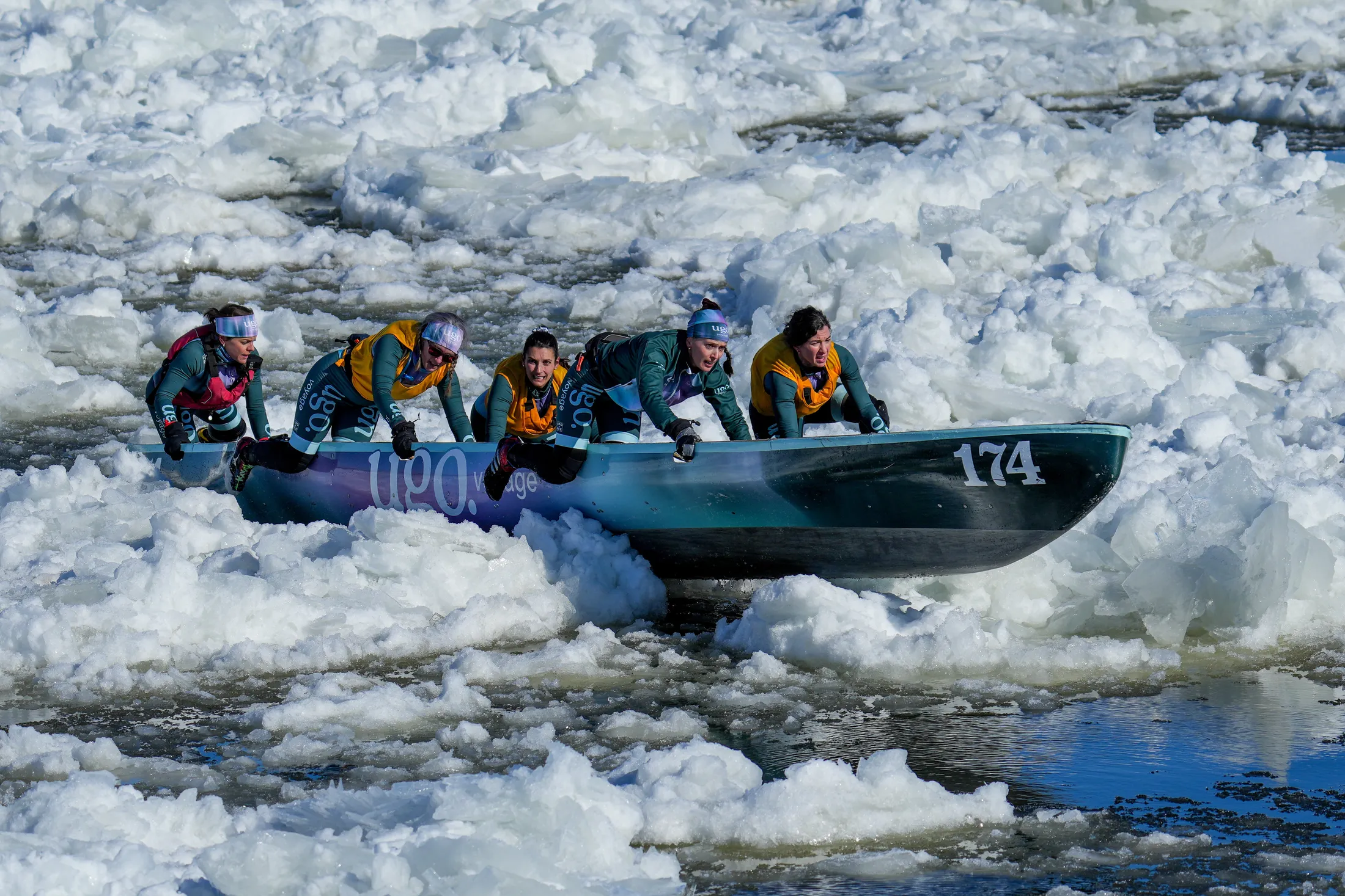 A team of women competes in the Quebec City Canaval ice canoe race.