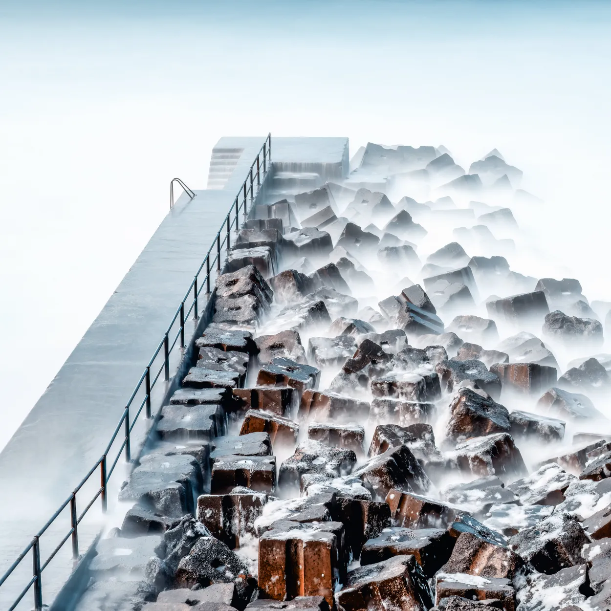 Madeira sea wall defence from the crashing ocean waves with the pier and steps