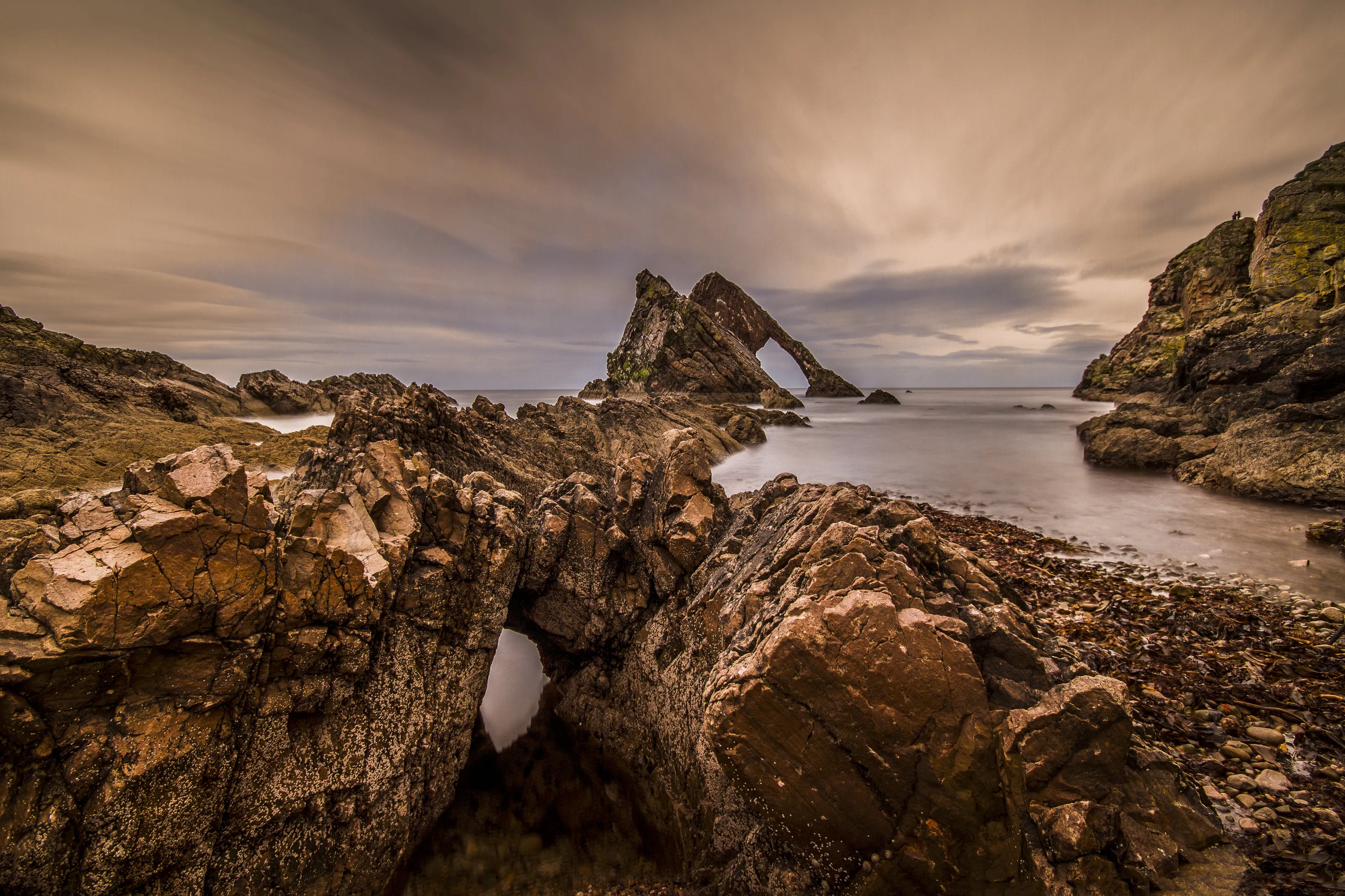 Evening colours at a famous natural sea arch, Bow Fiddle Rock, Portknockie, Moray, Scotland