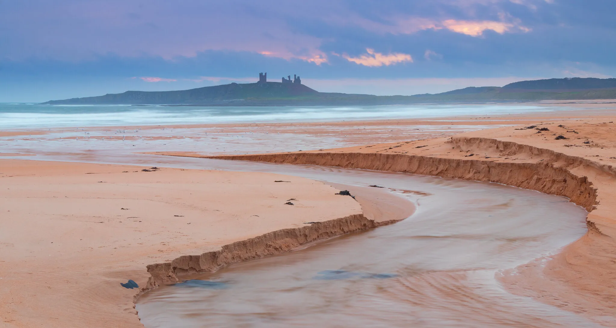 Embleton Beck and Dunstanburgh castle, Northumberland.
