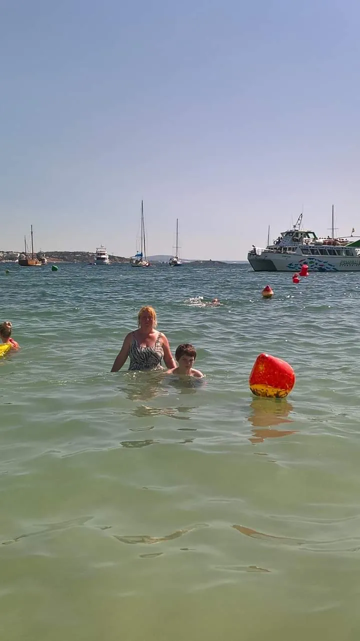 People Taking a Dip in the Sea