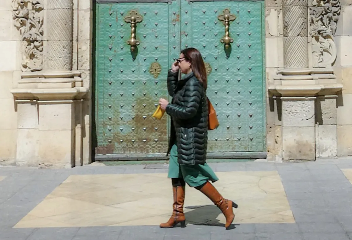 People Walking in Front of a Door