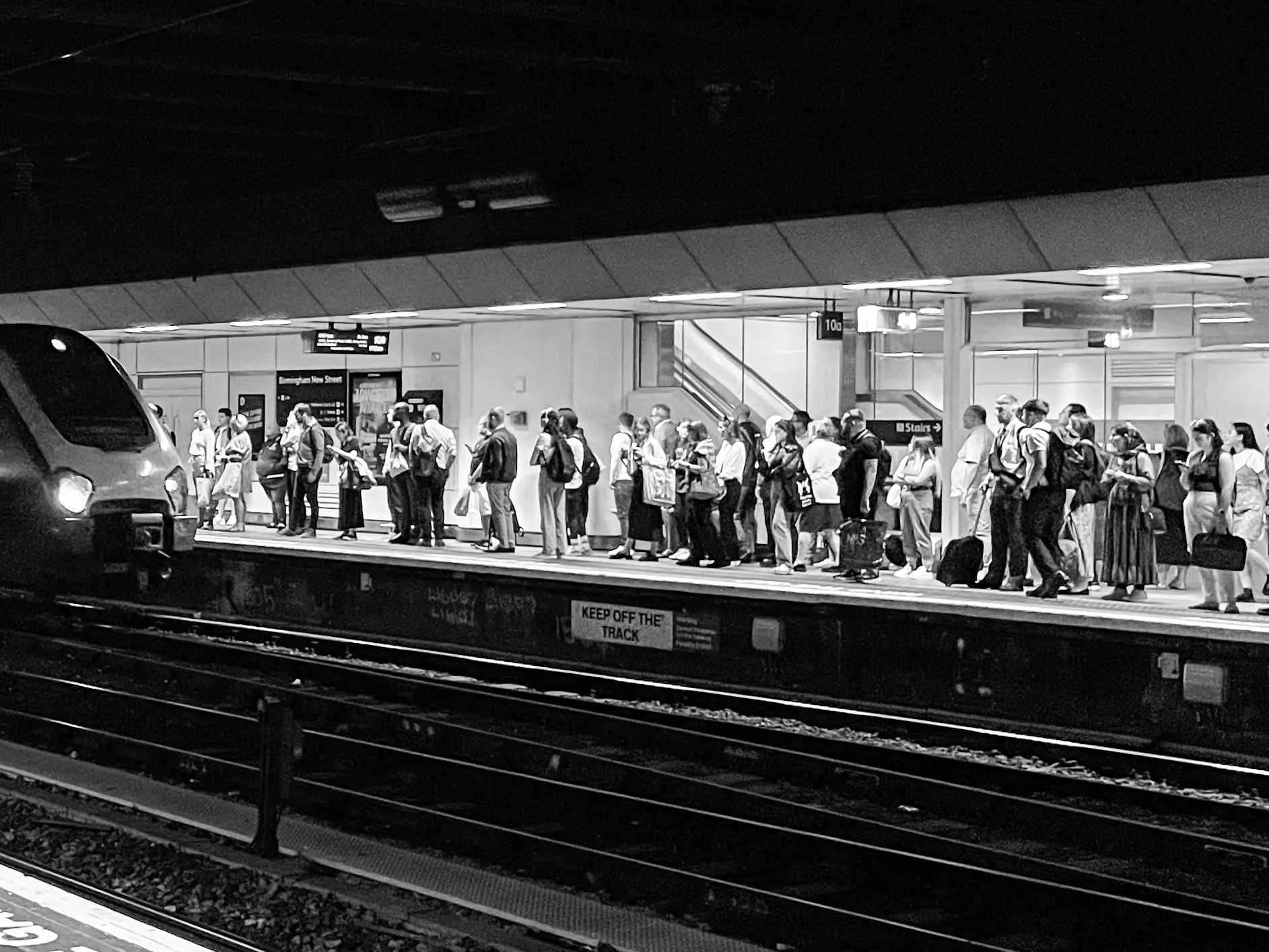 People Queuing or Waiting in Black and White