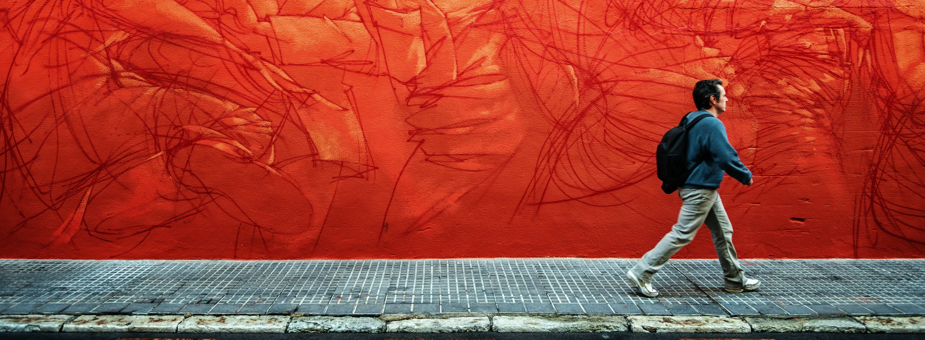 People walking past walls