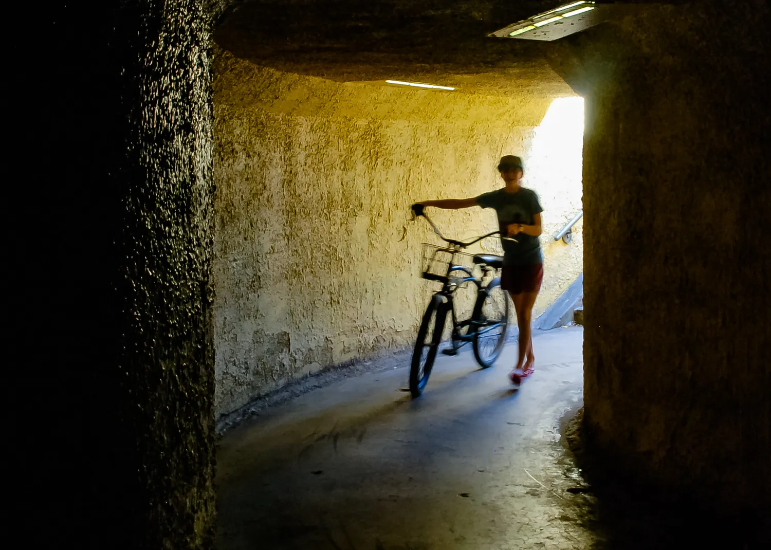 People in Silhouette in a Tunnel