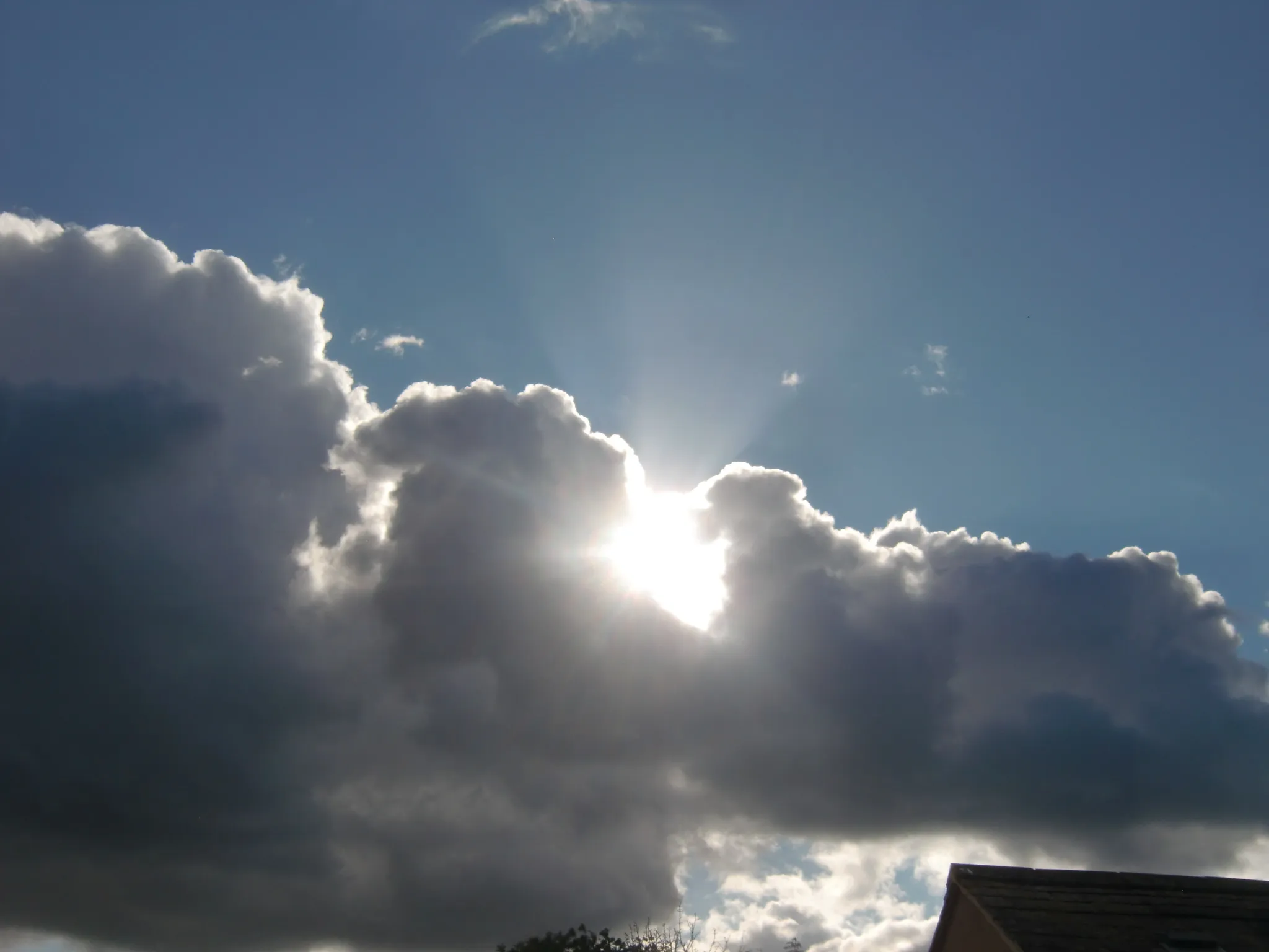 Sunlight Behind Dark Clouds (no sunrise/sunset)