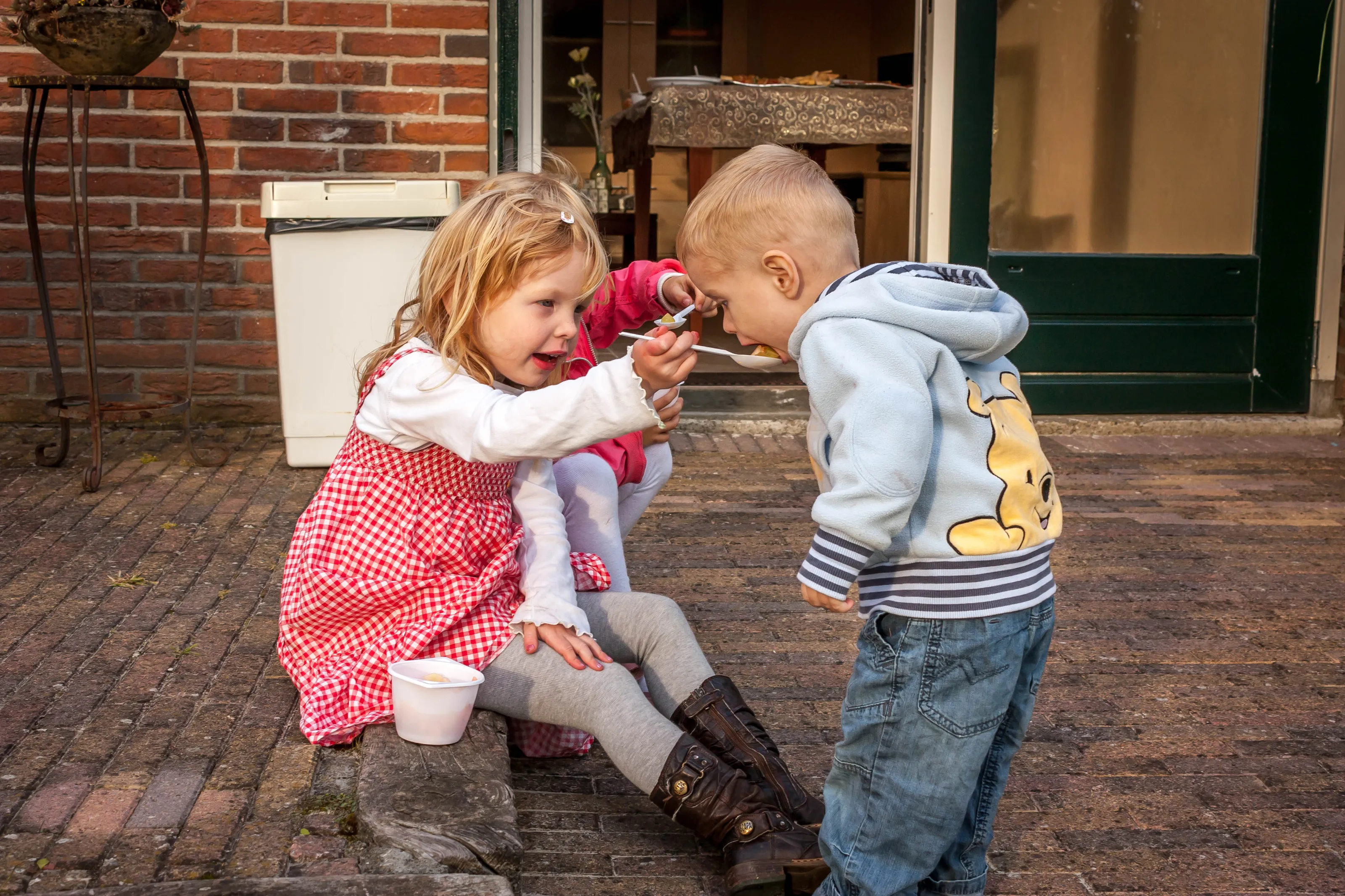 People Taking a Bite of Food