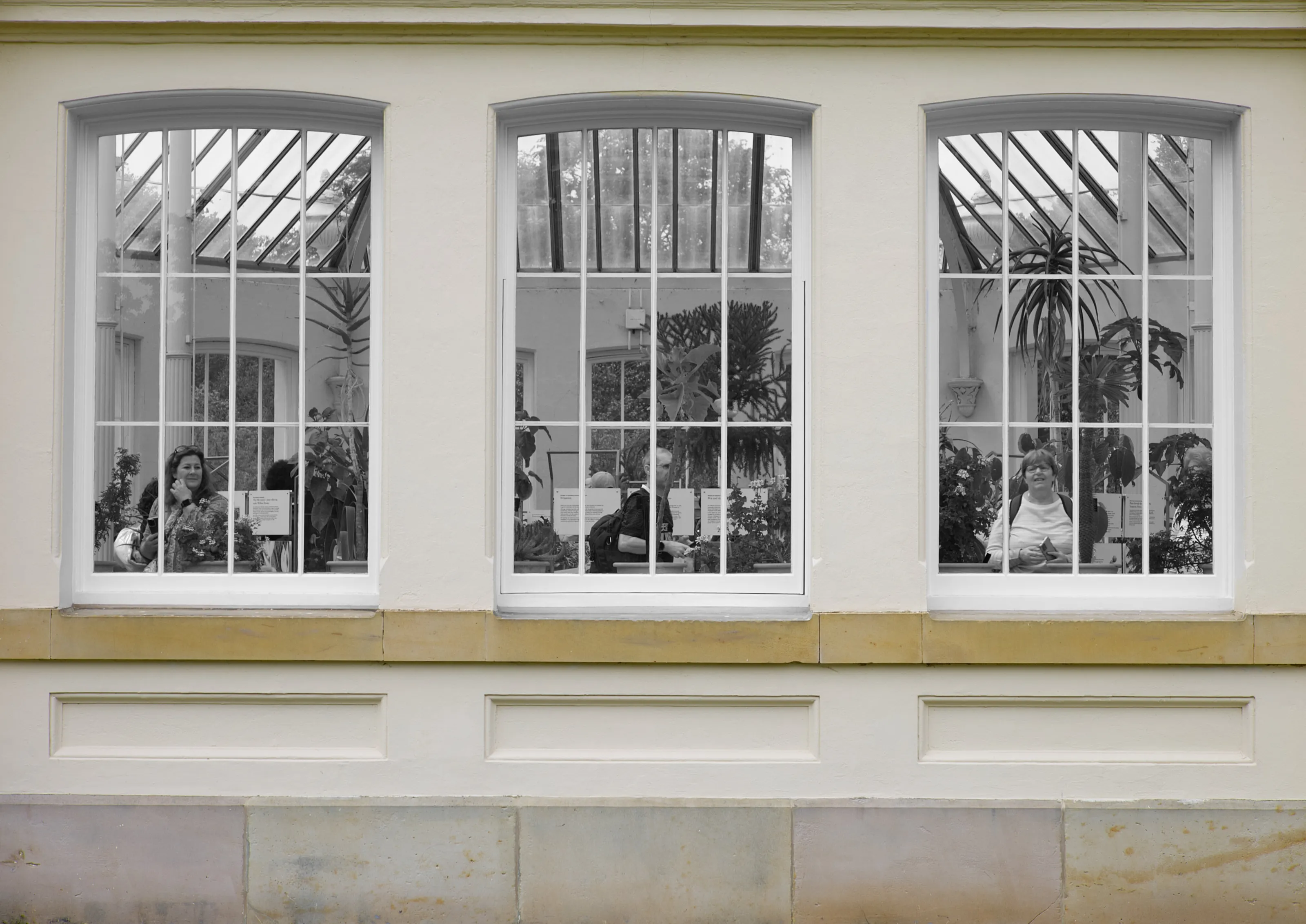 People Indoors Photographed Through Windows