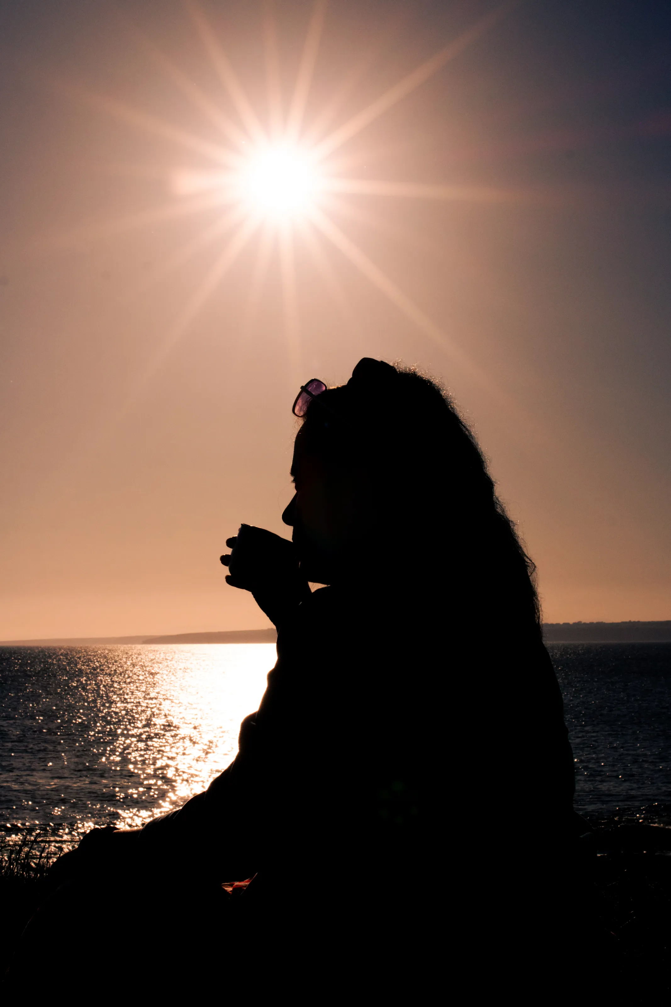 Kiss of sunray and a kiss on the cup of coffee at the cliff of Atlantic.