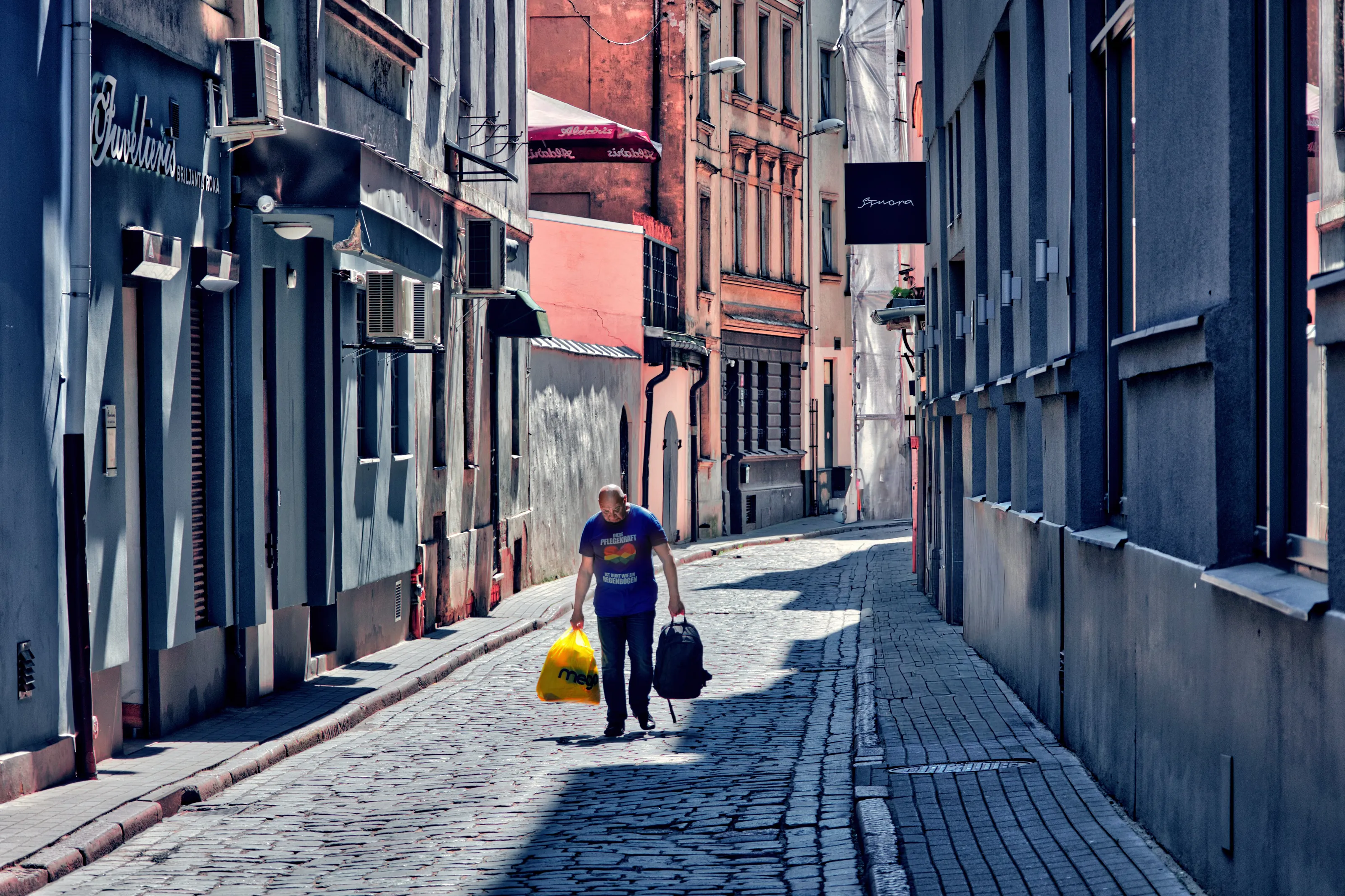 Man with bags in Riga, Latvia