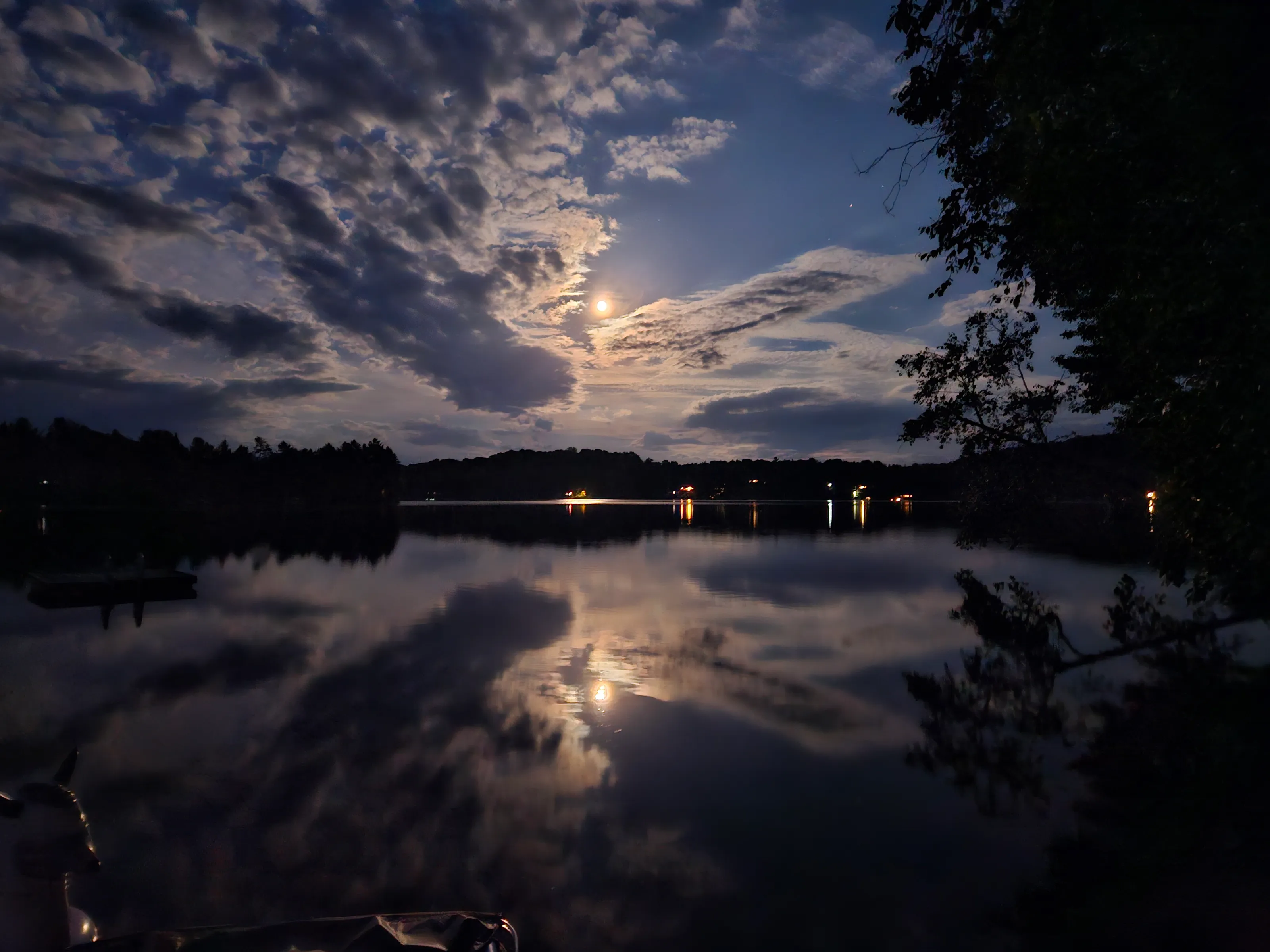 Cloudy skies and Moon over the lake