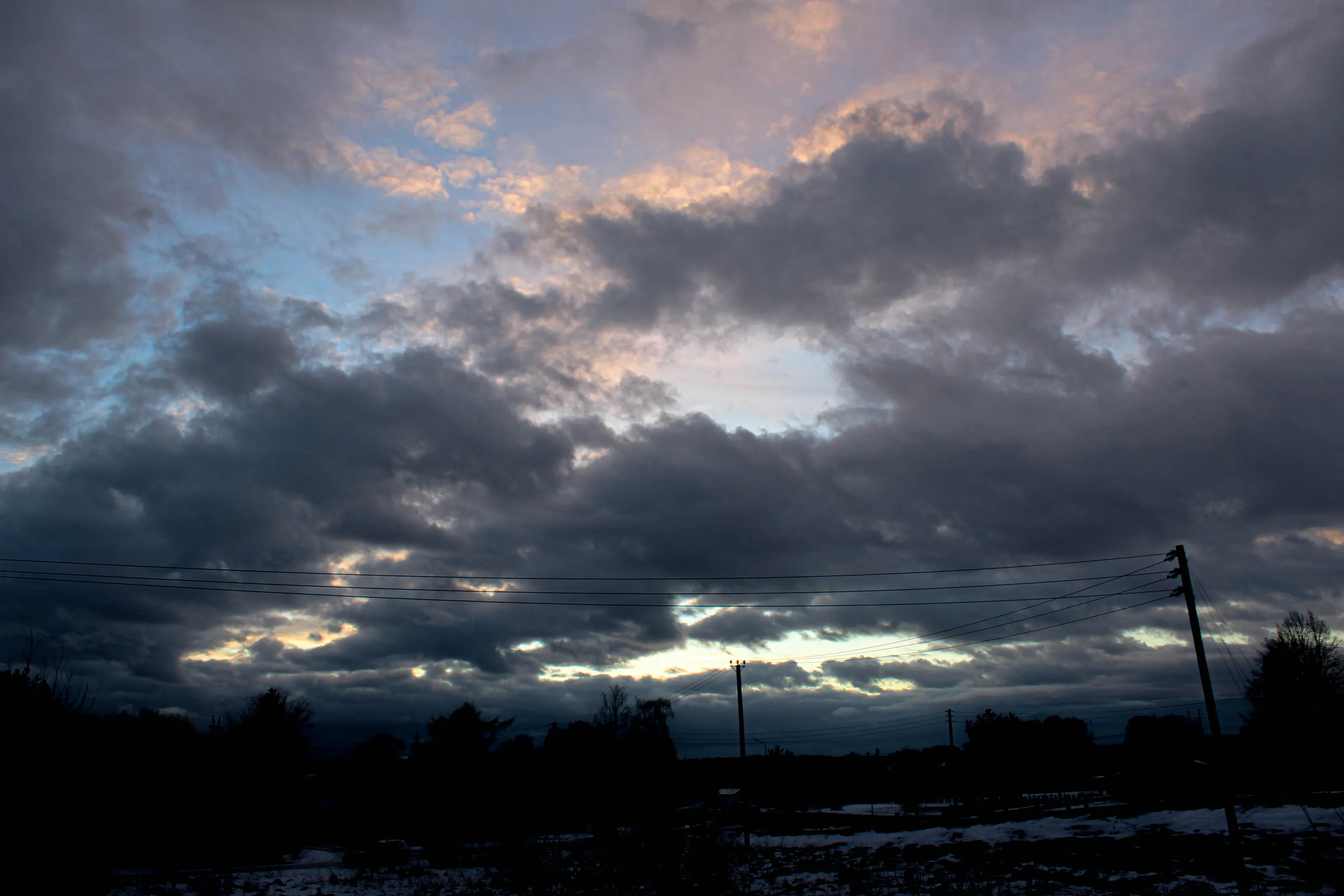 The sun, pale and low, stretched the shadows of a winter afternoon