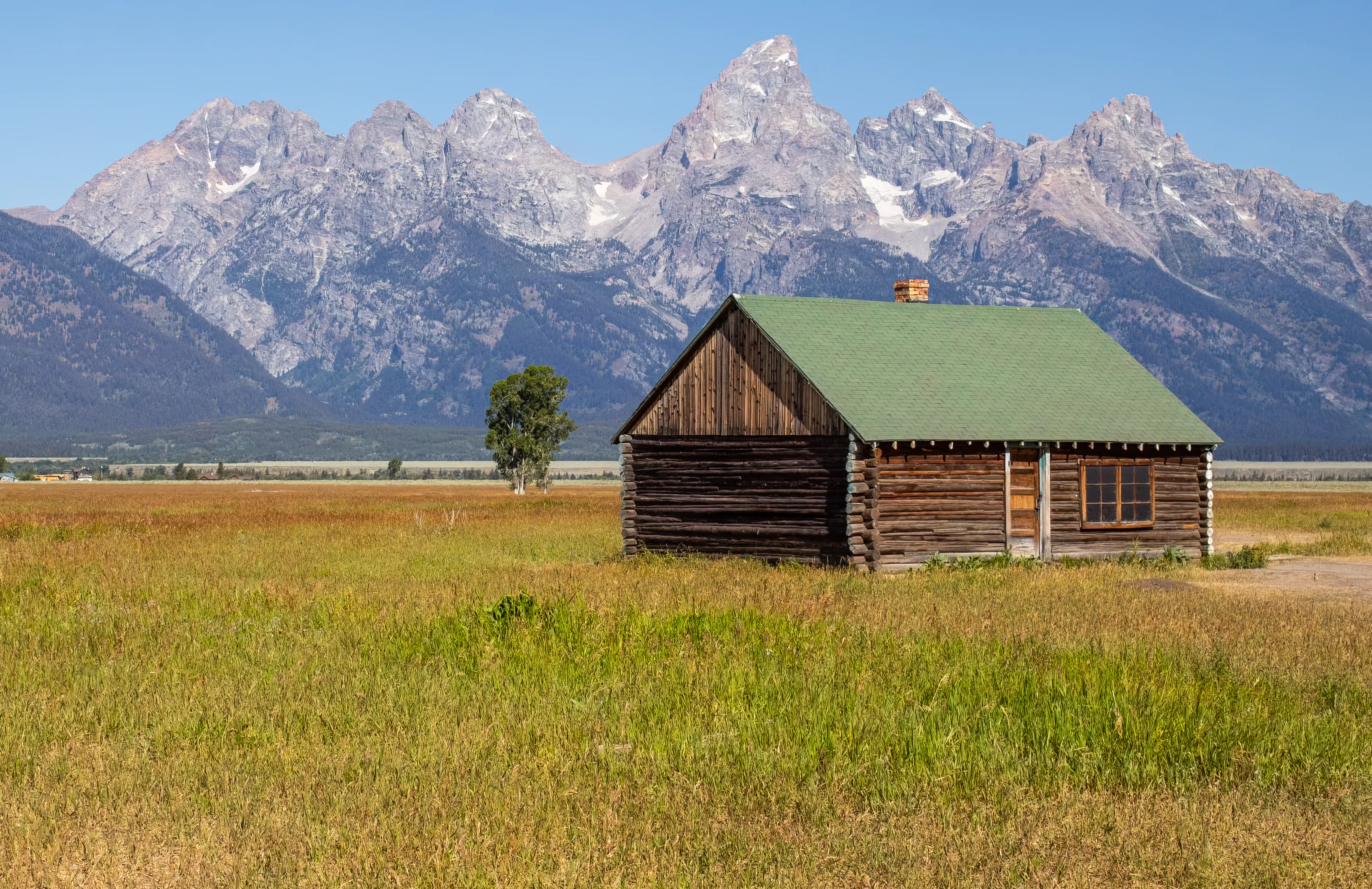 A old farm house resting in the open fields of Grand Teton, Wyoming