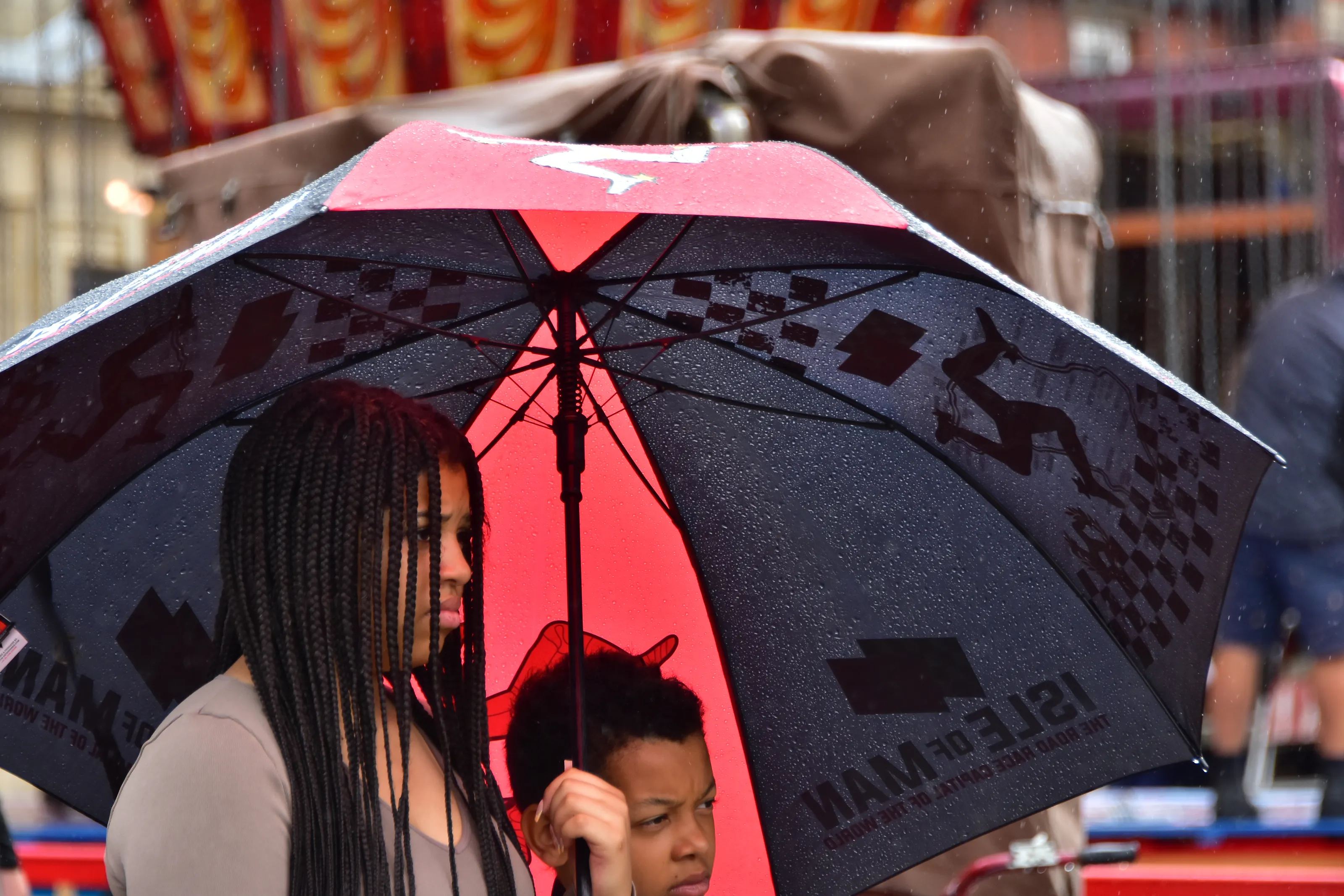 People Using Umbrellas with Logos