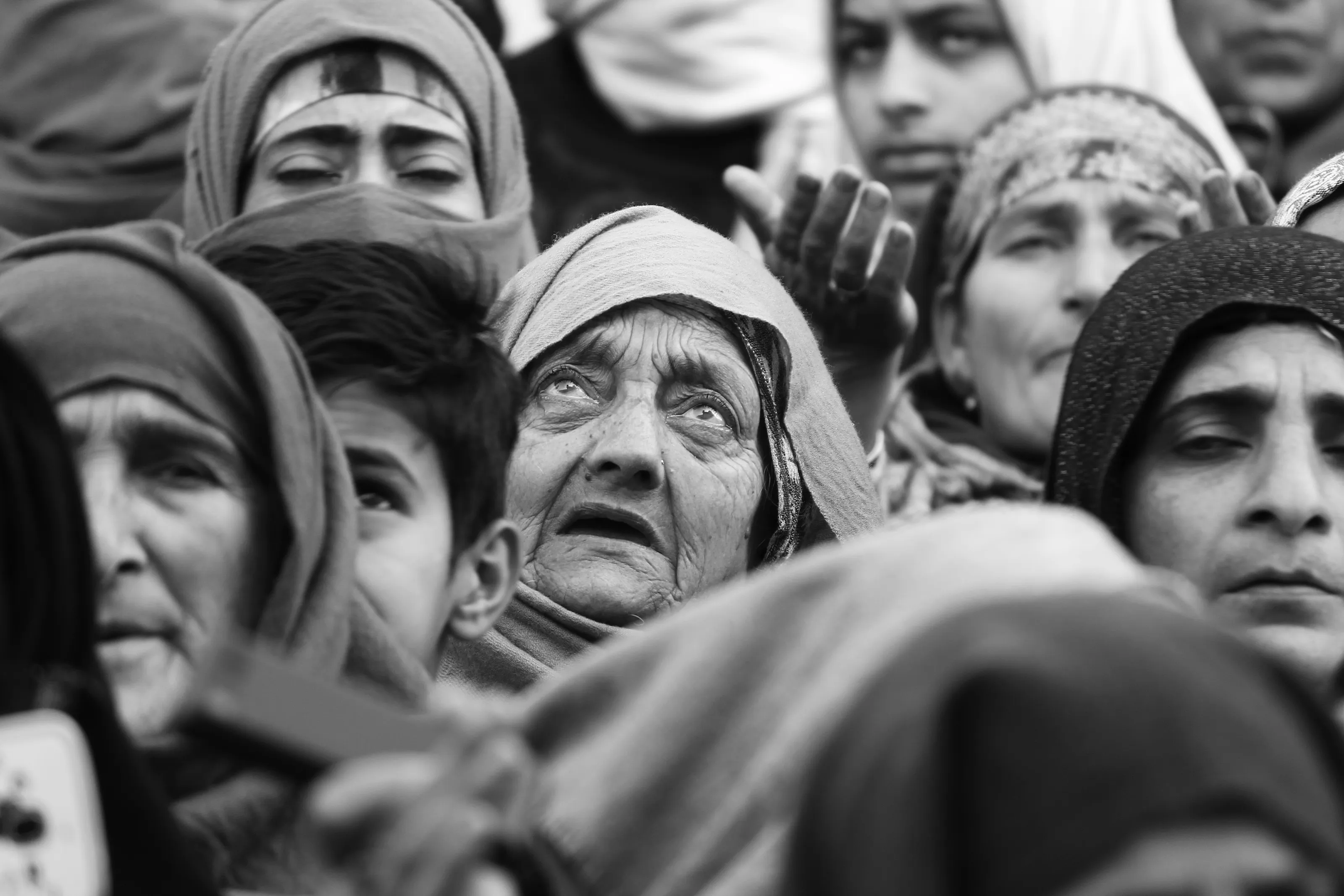 An older women looking at an unseen relic with wet eyes