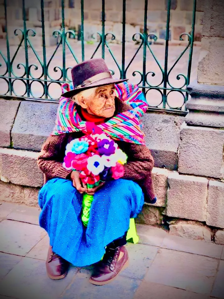 Old woman selling flowers in Machu Pichu