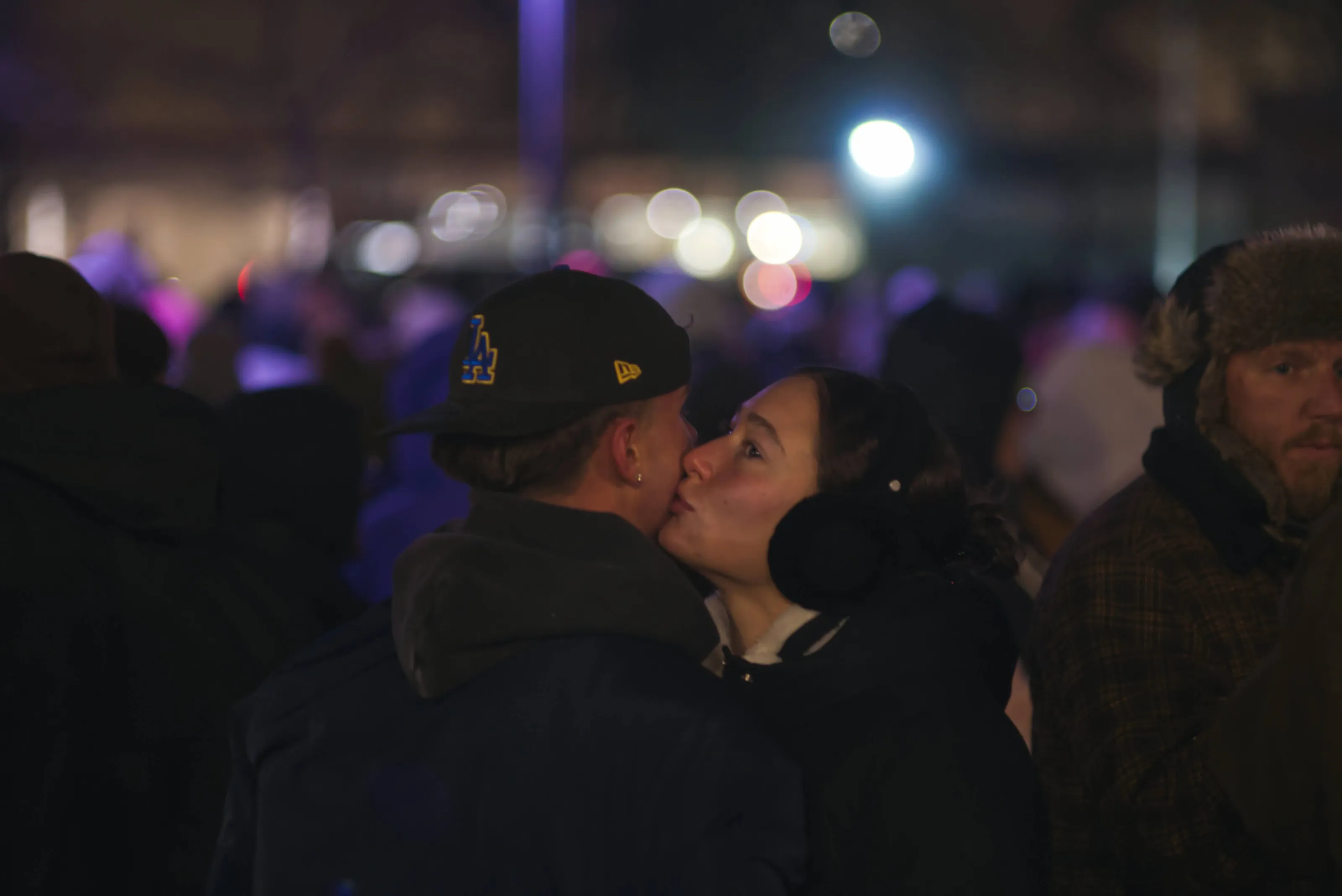 An affectionate couple at a crowded street festival