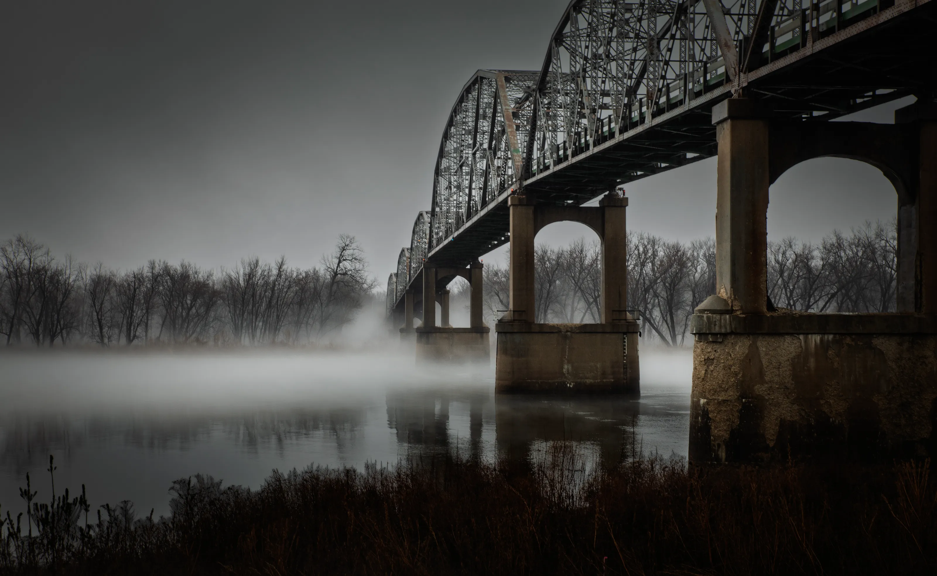 Bridge with foggy river