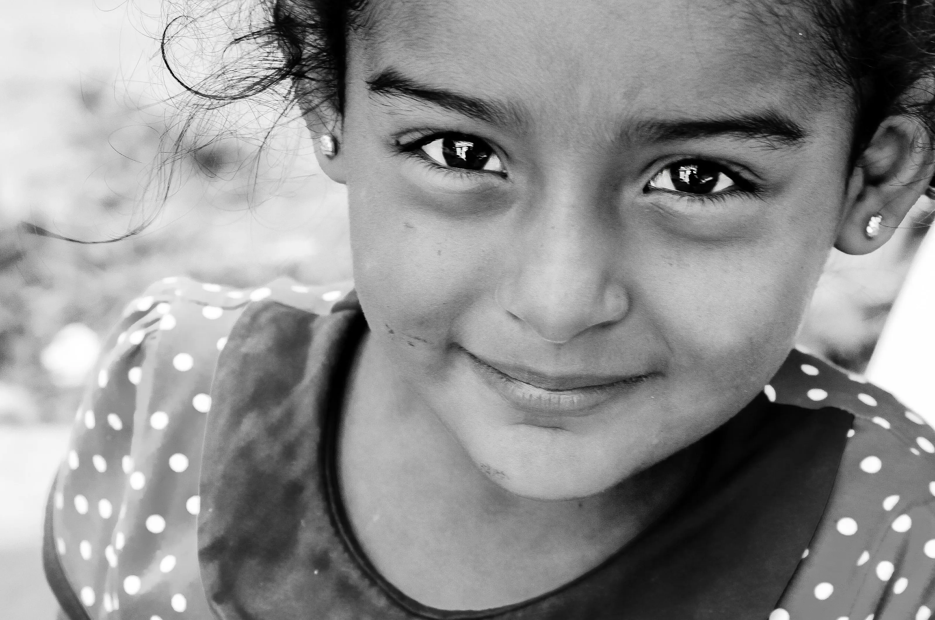 A beutiful kid with smiling eyes, capturing the innocennse and naive moment