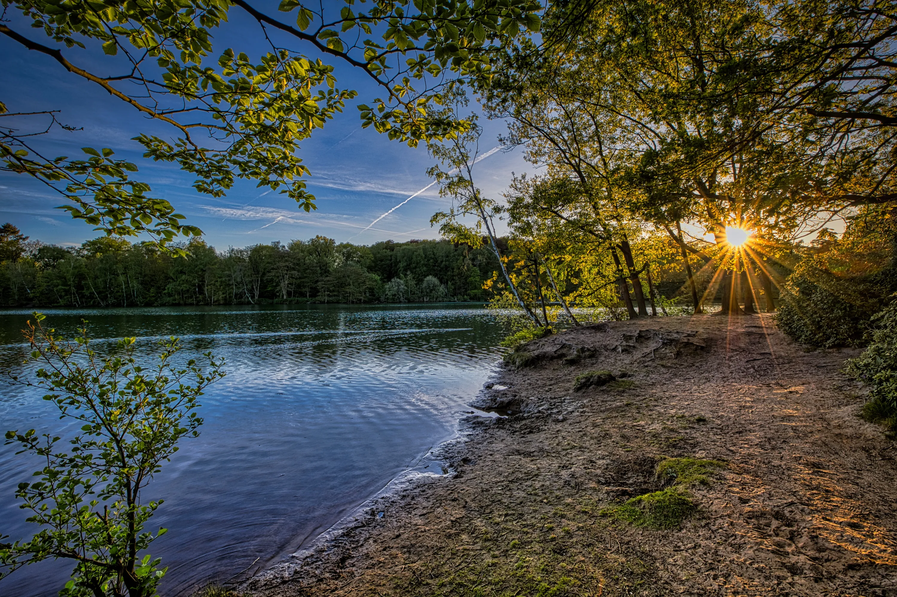 Beach on lake with sunburst