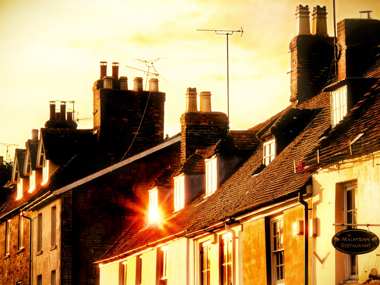 Chimneys and rooftops at sunset