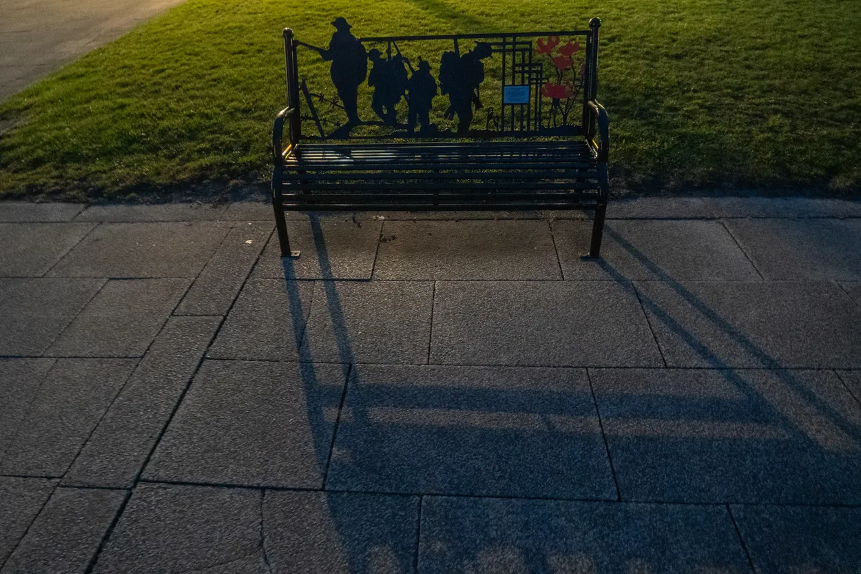 War memorial bench at night