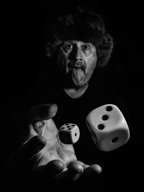 Shaking the dice with tongue in black and white