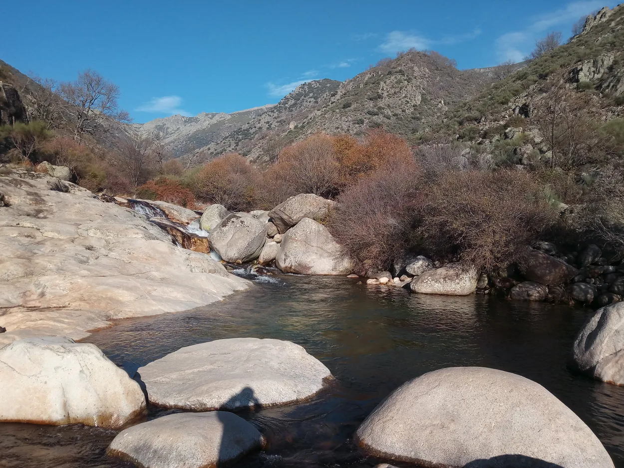Peaceful mountain landscape of Calajomero with a stream flowing through boulders
