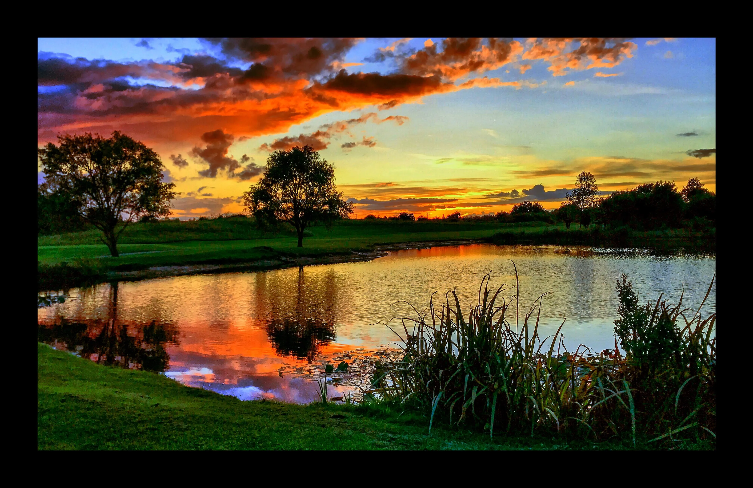 Sunset over golfing lake