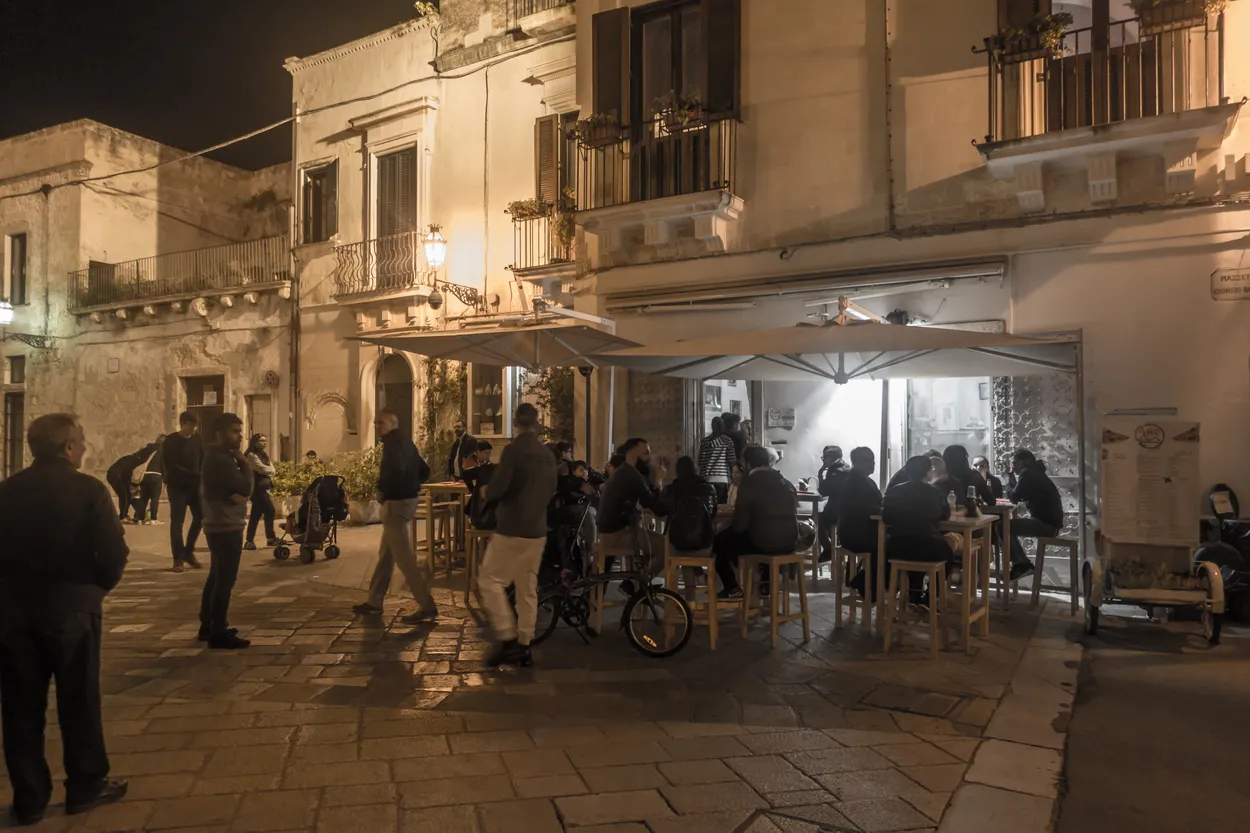 Outside tables at night. Ciro, Pizza restaurant, Lecce, Salento, Apulia, Italy.