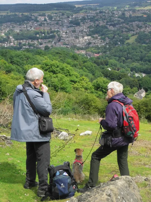 An older couple hiking at Heights of Abraham with their dog taking a break to snack [unedited]