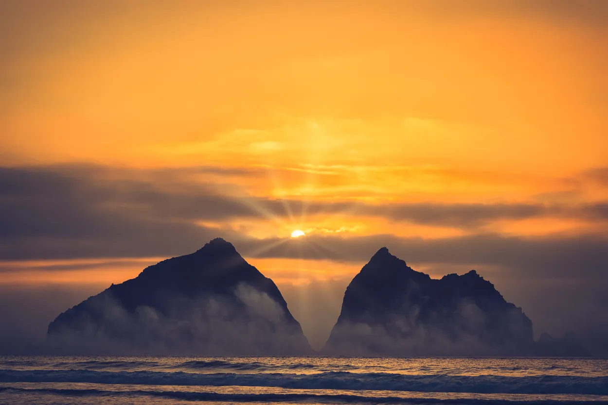 Holywell bay smoke and mist with sun rays Cornwall England uk