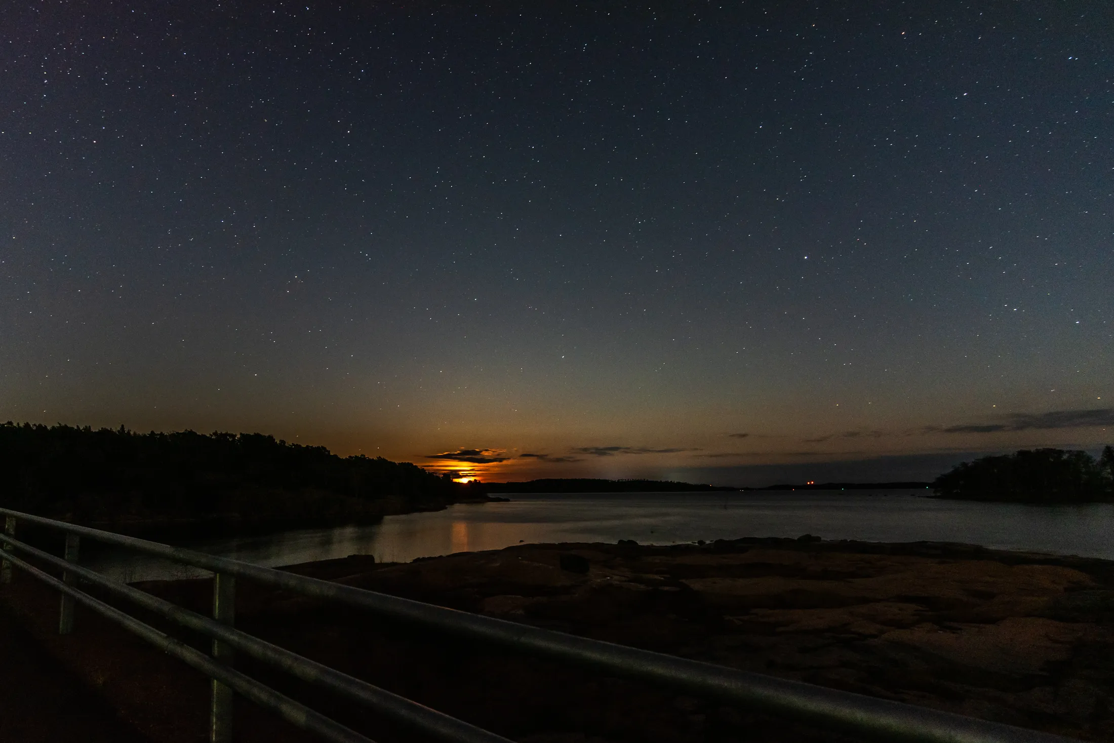 The moon rises on the horizon