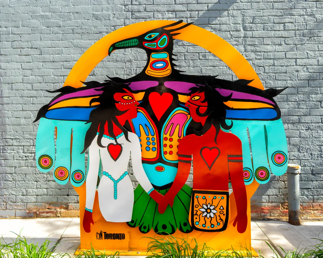 Cutout Style Sculpture in Front of a Wall