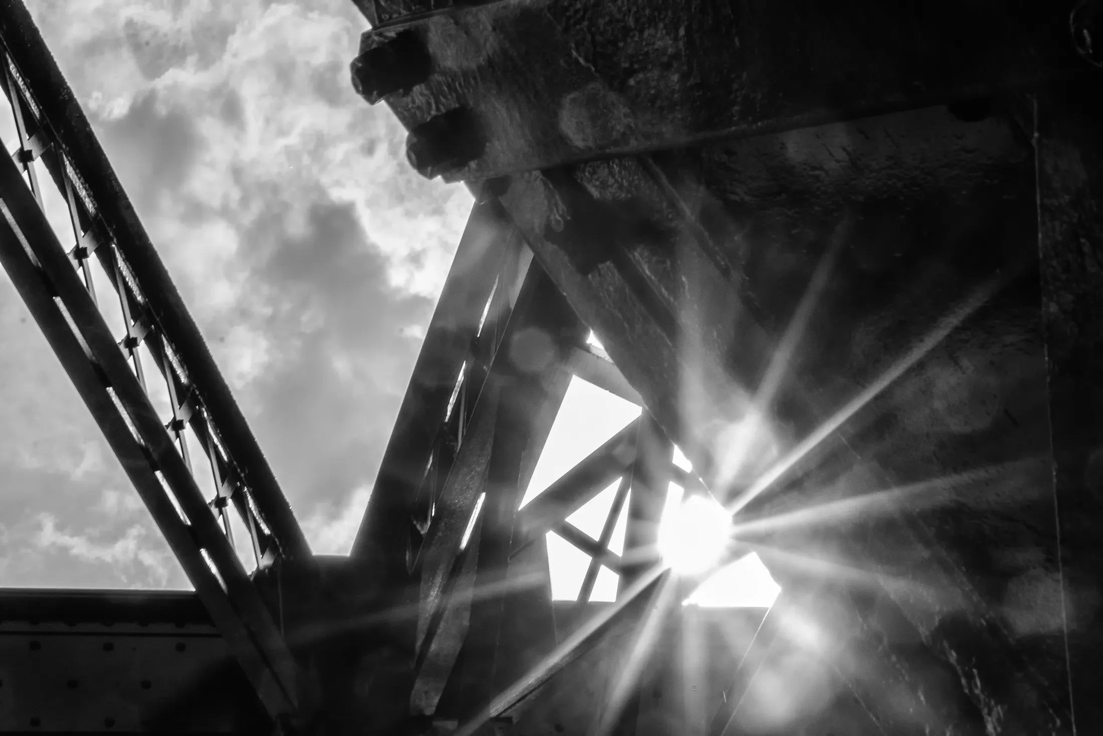 Sun with Lens Flare Through a Bridge