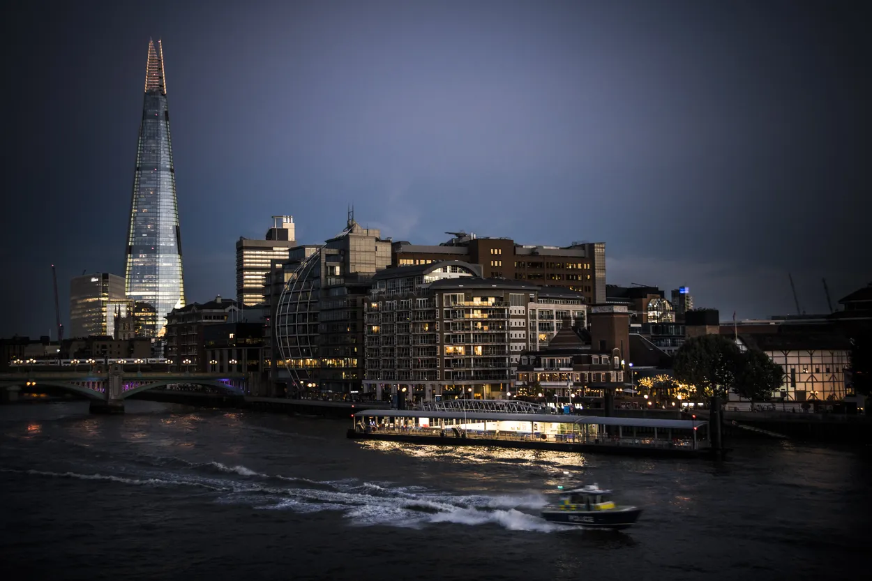 Speeding police boat on the Thames after dark