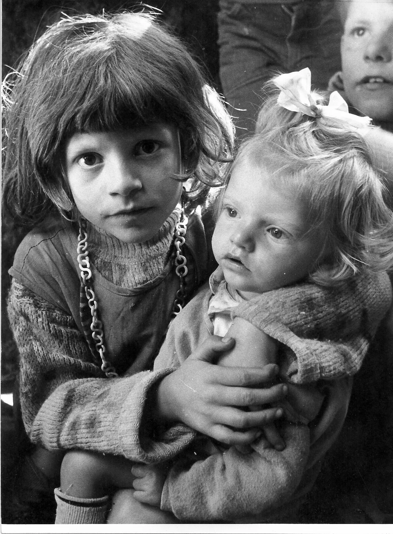 Girl with plastic necklace and smaller sister