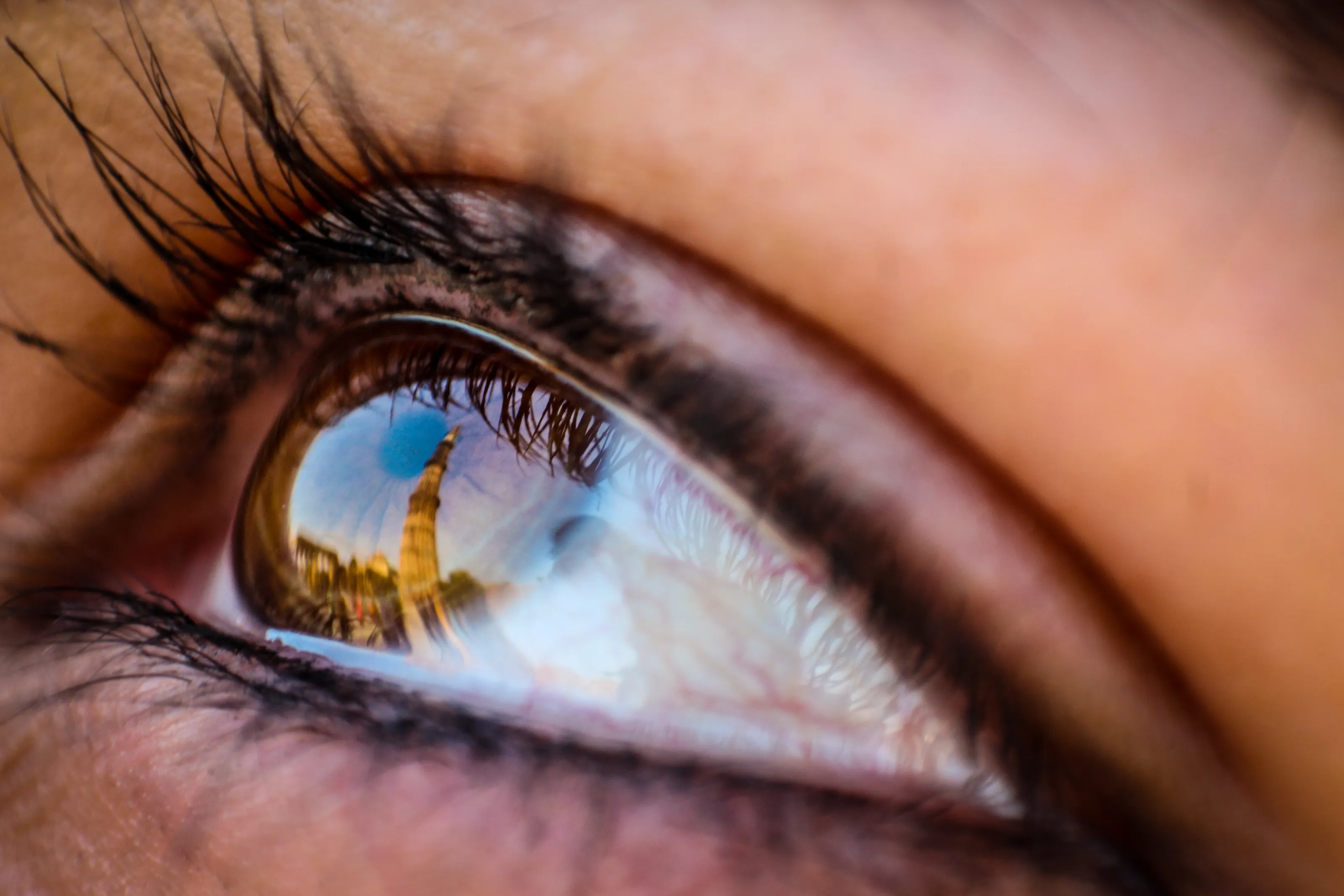 eye reflection of qutub minar delhi , india