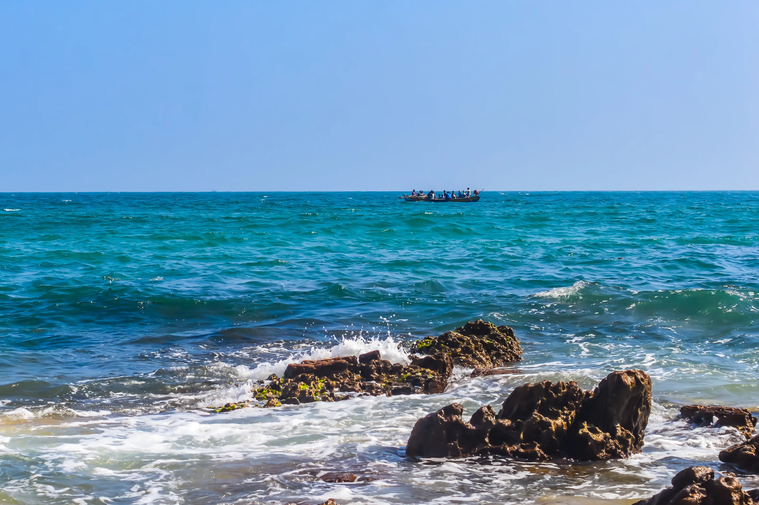 Photograph of Rowing Boat in Sea taken captured from a distance during Christmas Holiday