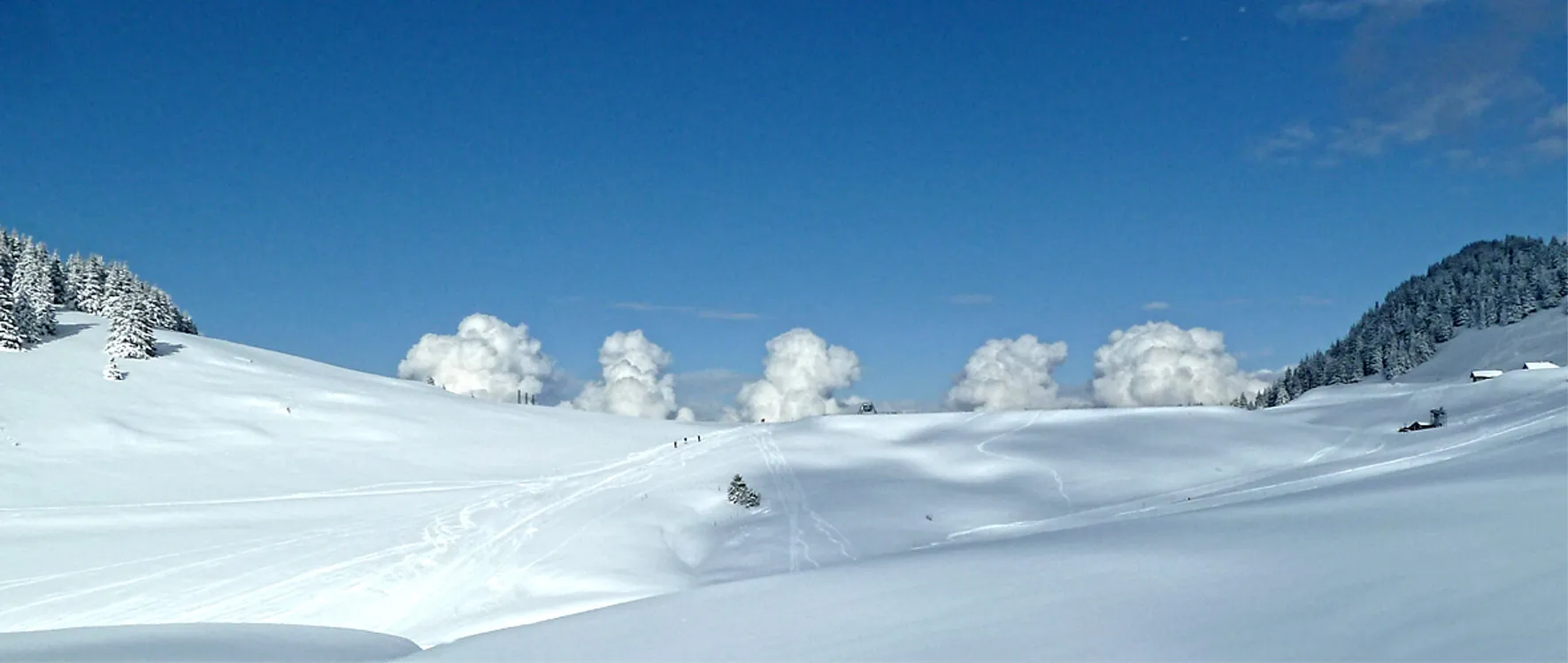A wide view of almost deserted ski slopes.