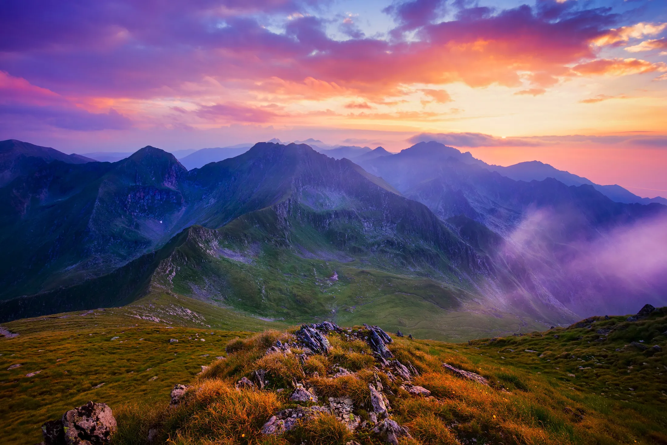 Beautiful sunset with cloudy sky in the Carpathian Mountains in Romania.