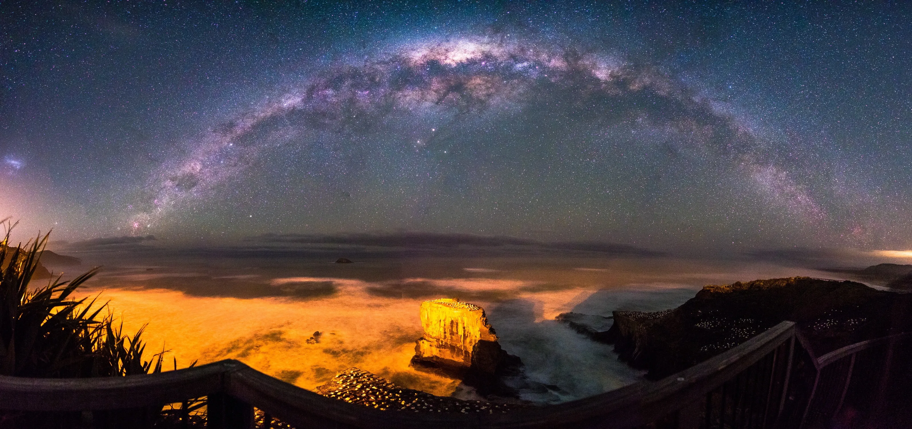 milky way arching over the muriwai gannet colony