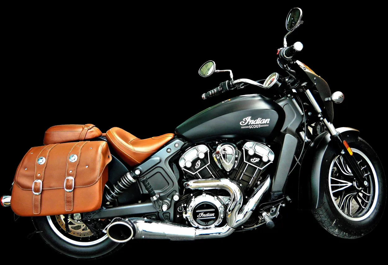 The Indian Scout motorcycle with the tan leather saddlebags matching the tan leather two-up seat