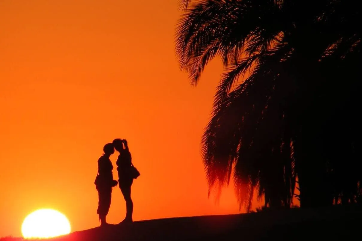 Sahara kiss, star crossed lovers on a desert evening.